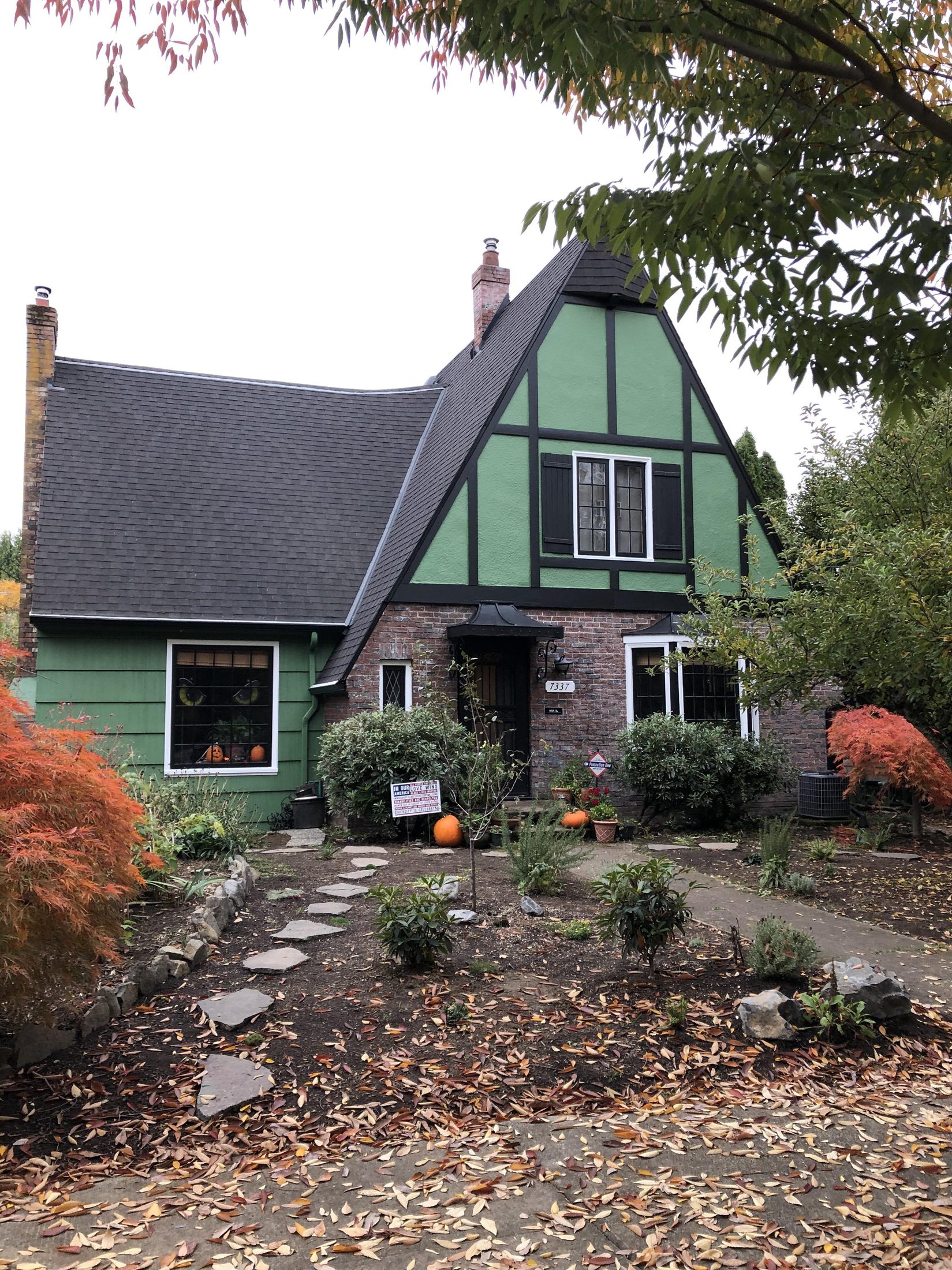 Green Tudor with red trim in autumn